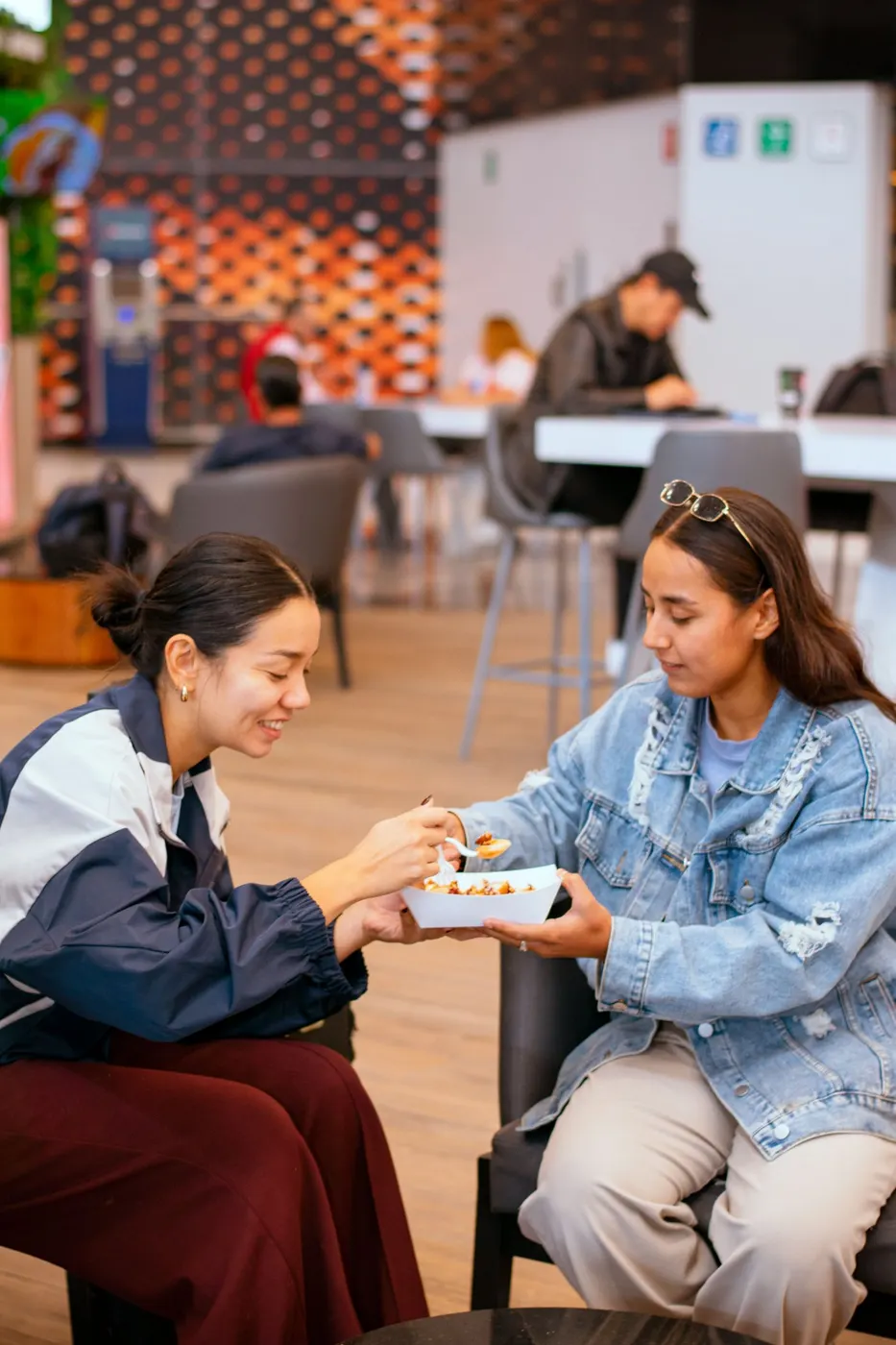 Two friends sharing food during a one-to-one casual hangout